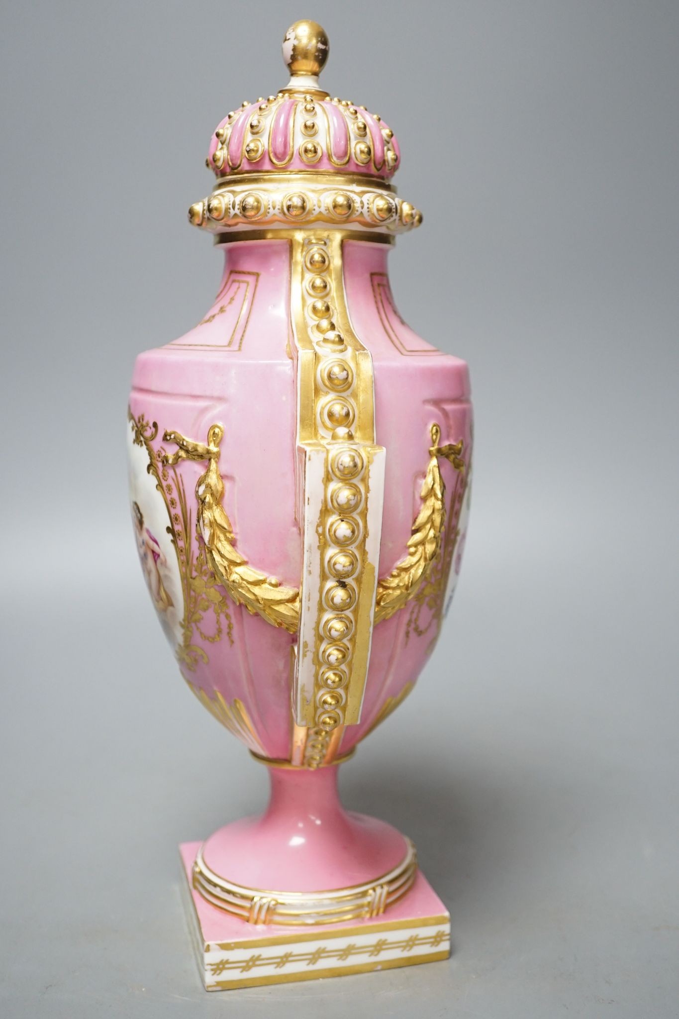 A Coalport two handled vase and cover painted with a Watteauesque scene to one side and a panel of fruit and flowers by William Cook 31cm